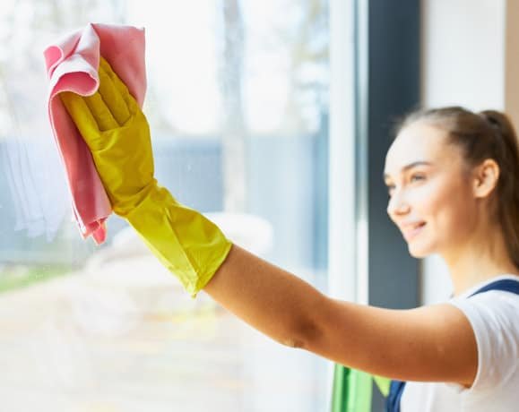 lady cleaning big glass window