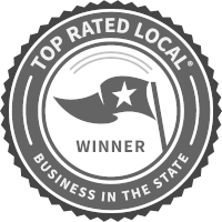 A circular logo with a ribbon at the top reading 